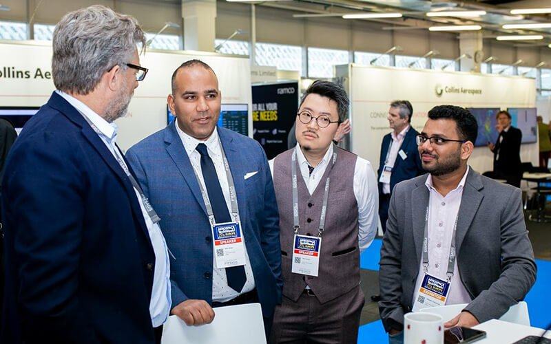 Executives reviewing account data at an industry event
